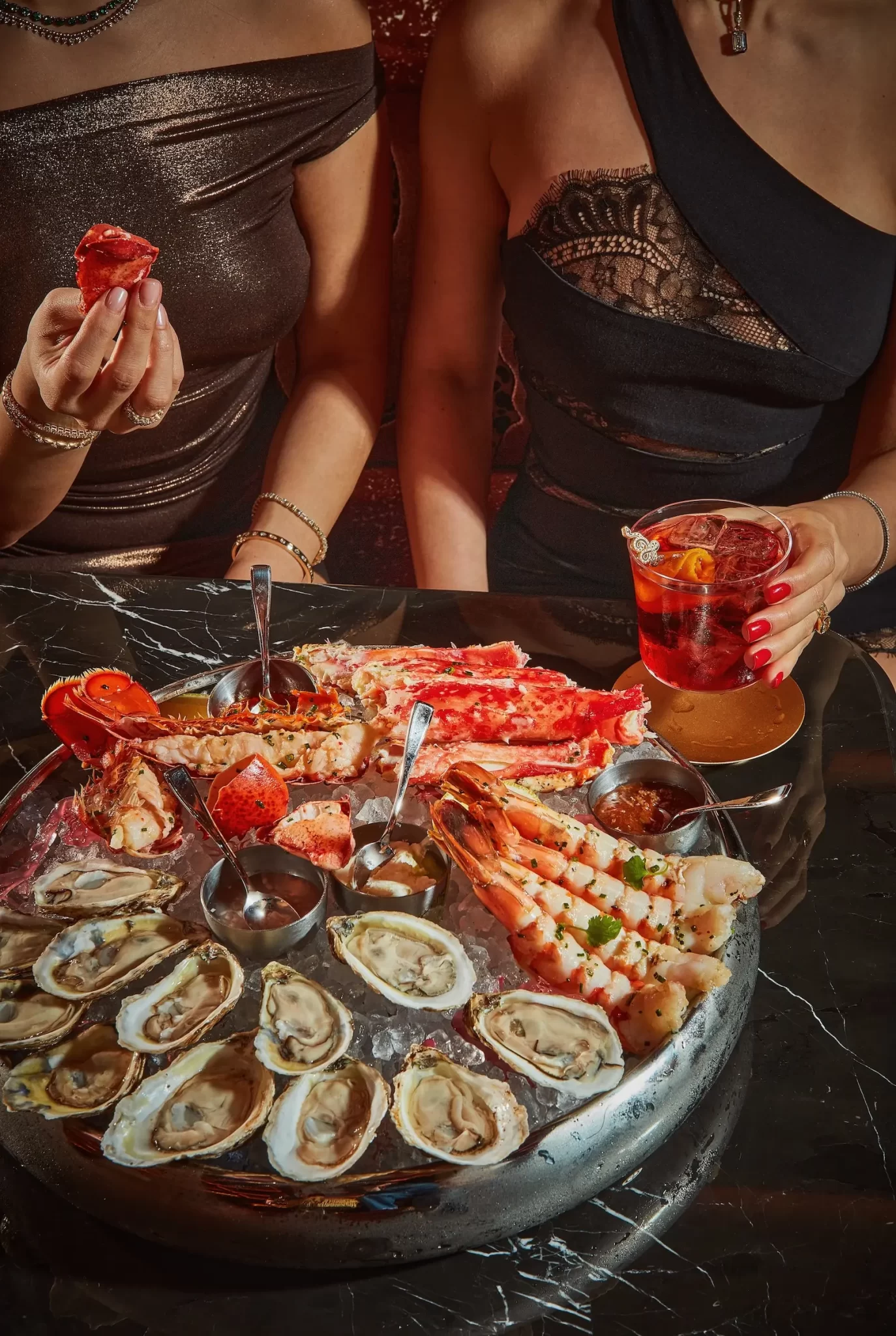 A decadent seafood platter featuring a variety of delicacies, including freshly shucked oysters, lobster and shrimp at Animl Steakhouse Toronto.